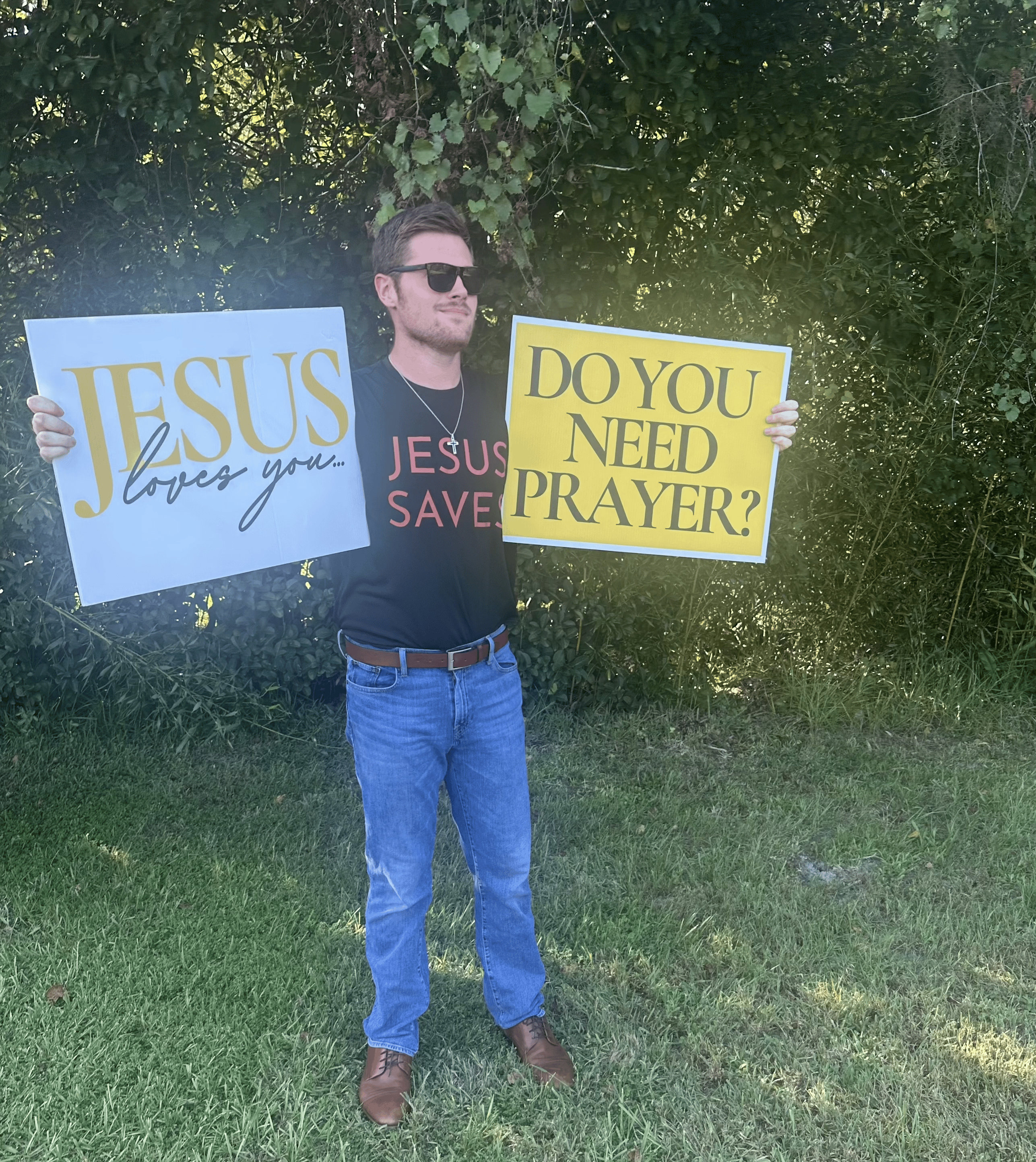 Holding a need prayer sign